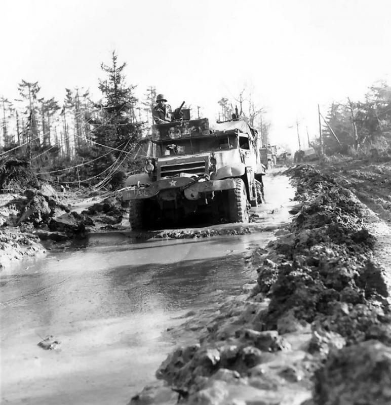 M3 Half-track vehicle of 16 Infantry Regiment on muddy road in the Hürtgen Forest