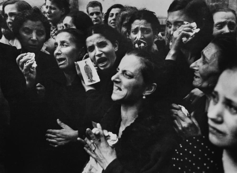 Photo by Robert Capa, women crying at funeral of twenty teenaged partisans